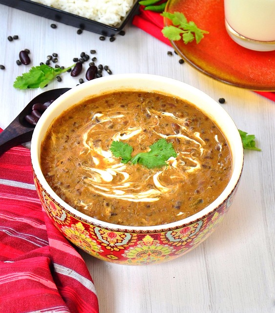 bowl of plain yogurt with spoon on cream background
